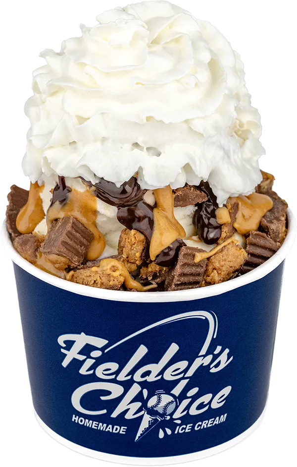 Delicious ice cream sundae with whipped cream, chocolate syrup, and peanut butter cups in a Fielder's Choice cup.