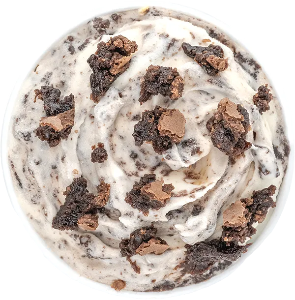 Cookies and cream ice cream with chunks of chocolate brownie, top view. Indulgent dessert treat.