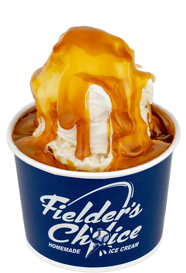 Creamy vanilla ice cream drizzled with caramel sauce in a branded Fielder's Choice cup.