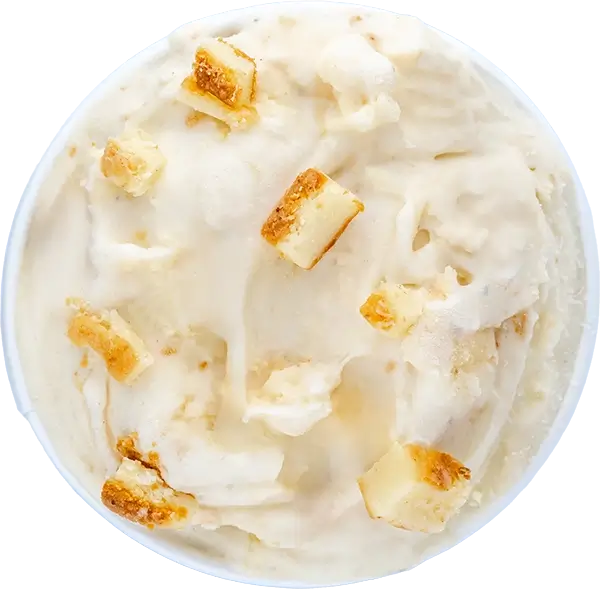 Creamy vanilla ice cream with Cheesecake chunks in a bowl, top view.