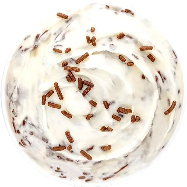 Close-up of vanilla ice cream swirl with chocolate sprinkles on top, viewed from above for dessert lovers.