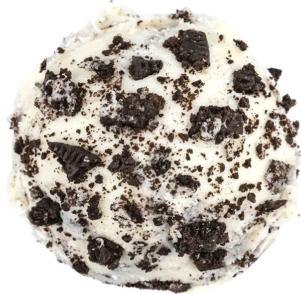 Scoop of cookies and cream ice cream with chocolate cookie chunks scattered on top.