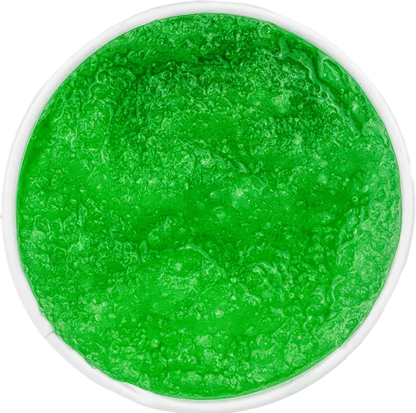 Bright green slushy drink in a cup viewed from above, with a frothy icy texture.