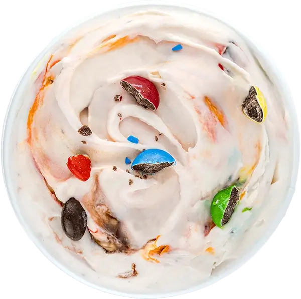 Creamy vanilla ice cream swirl with colorful chocolate candy pieces on top.