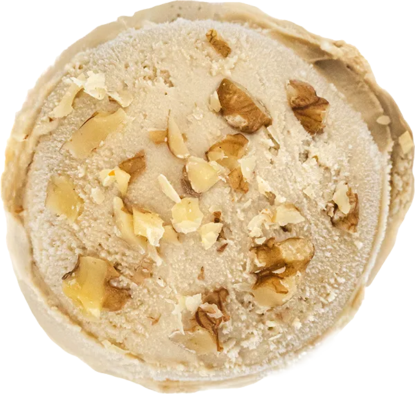 Creamy ice cream scoop with crunchy walnut pieces on top. Perfect dessert detail for nutty flavor lovers.