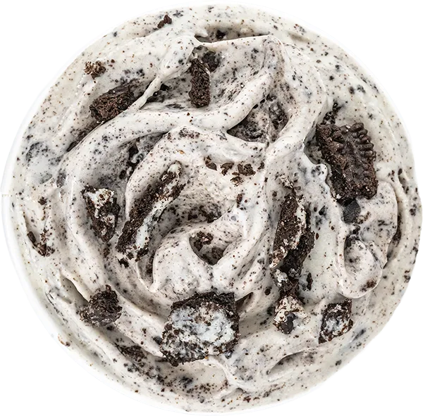 Creamy cookies and cream ice cream with chocolate cookie chunks in a bowl, top view.