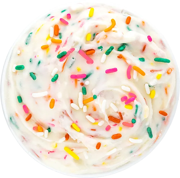 Colorful sprinkles on creamy vanilla icing, top view. Perfect dessert for birthdays and celebrations. Indulgent treat!