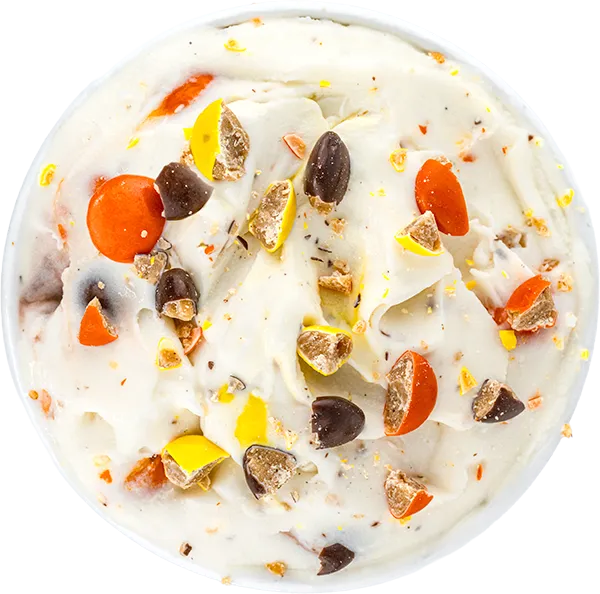 Delicious creamy ice cream topped with colorful candy pieces and chocolate chunks. Perfect sweet treat for dessert lovers.