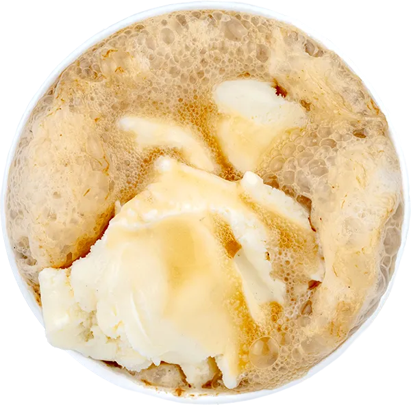 Creamy vanilla ice cream with frosty root beer in a foamy root beer float, viewed from above.