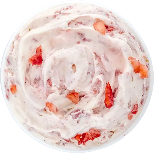 Creamy strawberry ice cream with fresh strawberry chunks, viewed from above, in a circular swirl pattern.