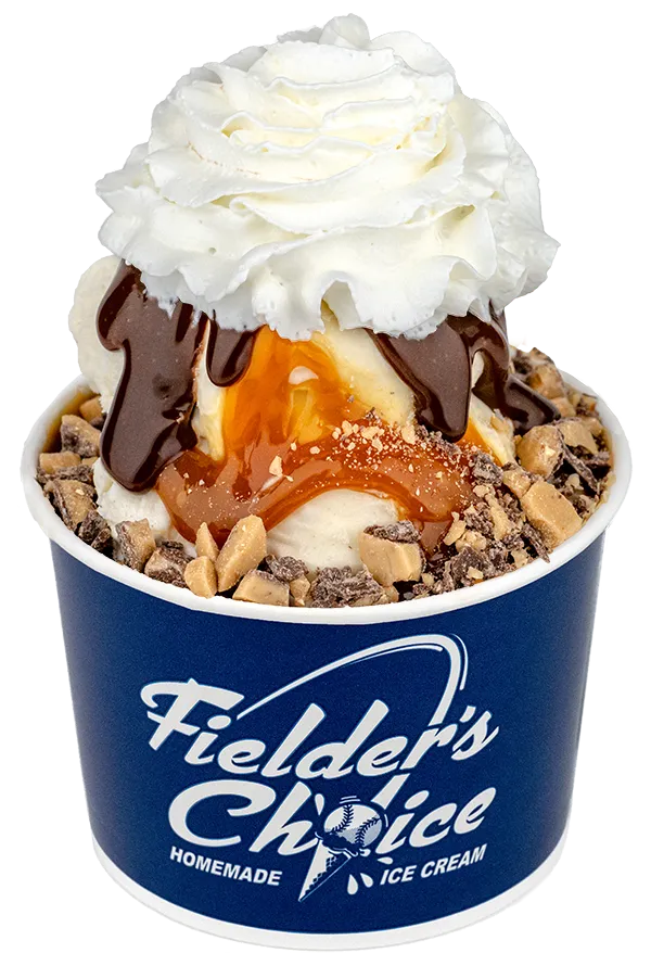 Delicious homemade ice cream with whipped cream, chocolate, caramel, and toffee bits in a Fielder's Choice cup.