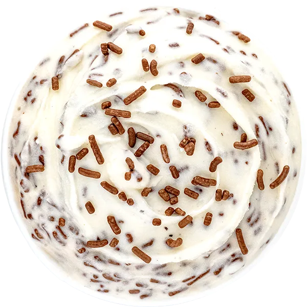 Close-up of vanilla ice cream swirl with chocolate sprinkles on top, viewed from above for dessert lovers.